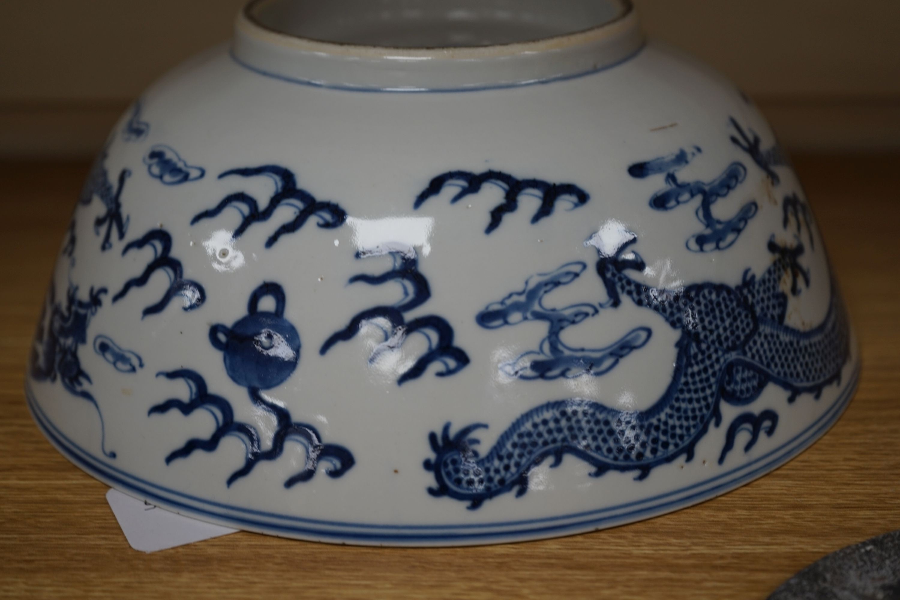 A Chinese blue and white ‘dragon’ bowl, Kangxi mark, late 19th century 25cm